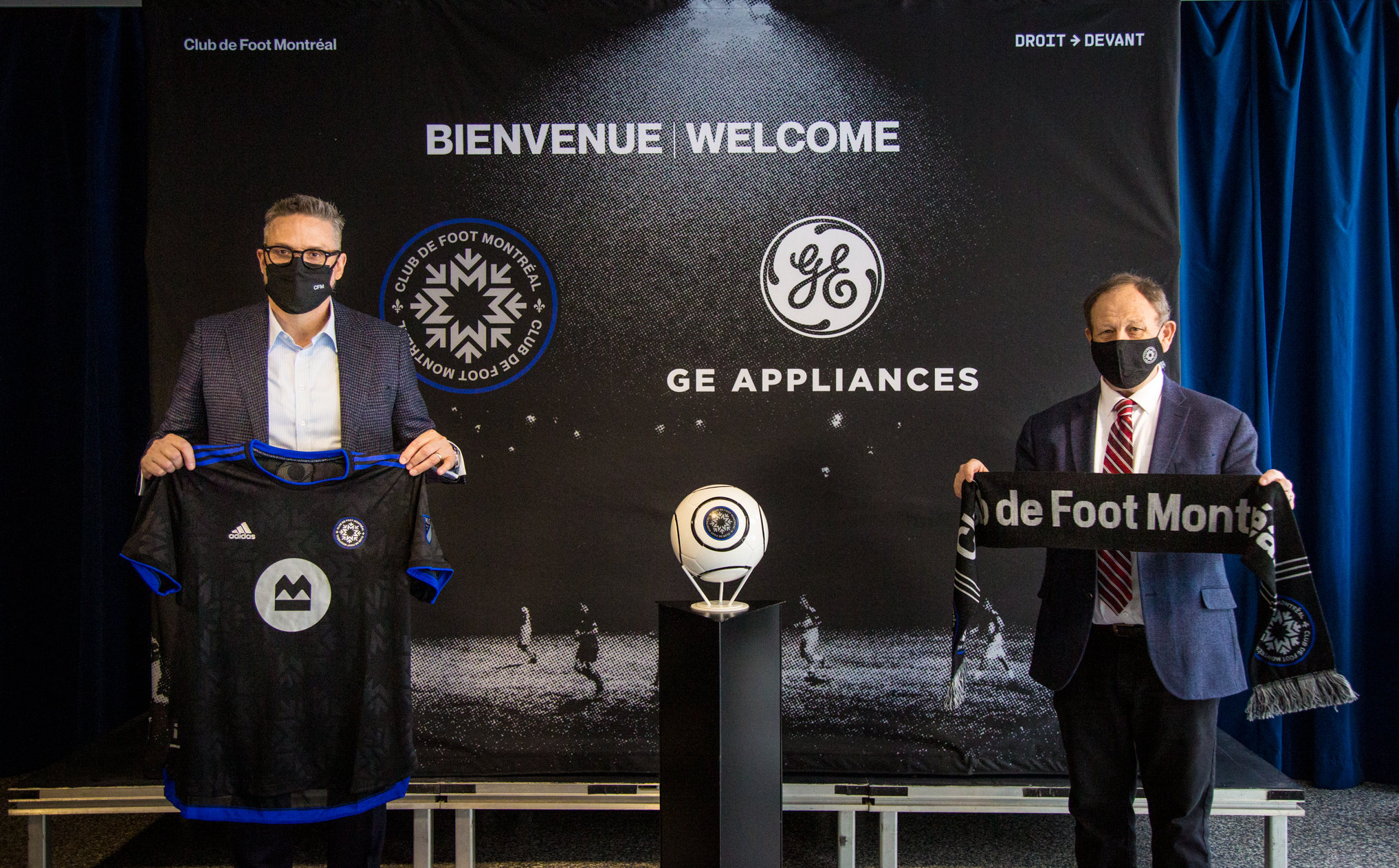 men holding jersey and scarf at cf montreal welcome release